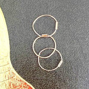 A pair and a spare of small/medium 10K gold hoops